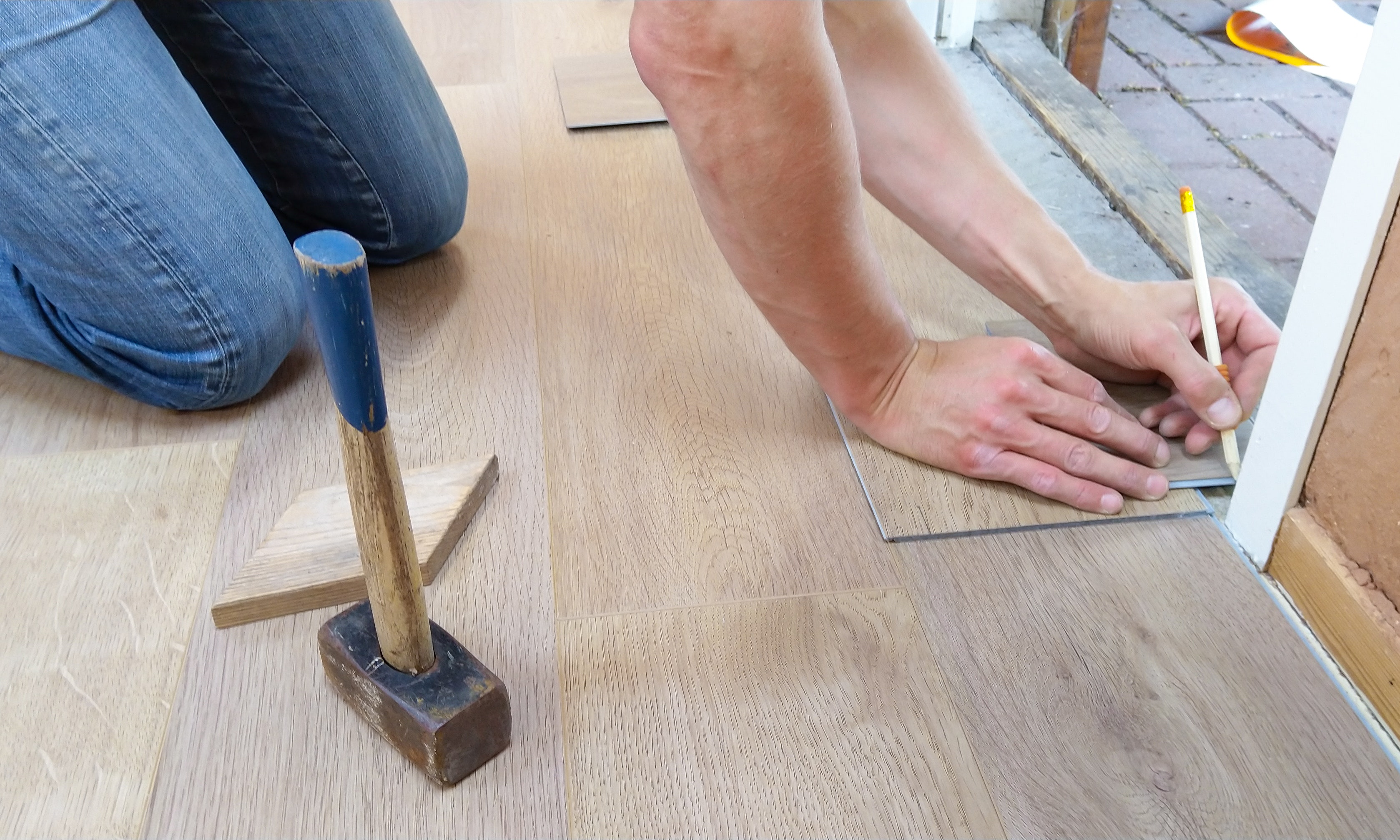 person measuring flooring for a home renovation